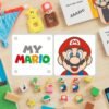 Un'immagine colorata che mostra i vari prodotti della serie My Mario: un set di blocchi di legno, il libro "Hello, Mario!" e l'interfaccia dell'app.