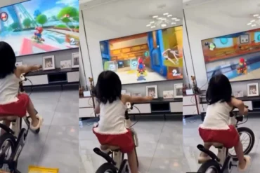 Video virale su X di una bambina che pedala su una bicicletta trasformata in cyclette mentre gioca a Mario Kart World su Nintendo Switch 2 con i comandi di movimento del Joy-Co